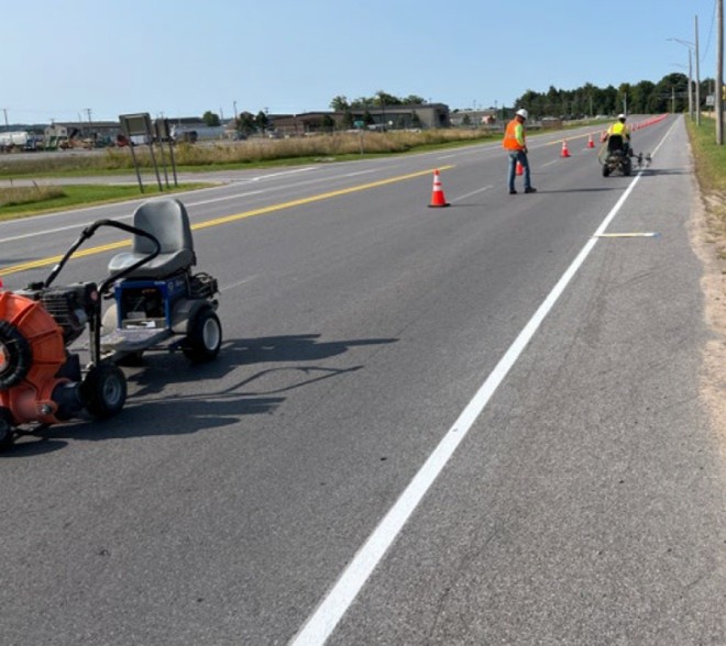 Biobased pavement marking paint being applied to a road on a DoW installation.